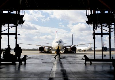 silhouetted-figures-work-around-an-aircraft-inside-2024-08-19-20-38-57-utc